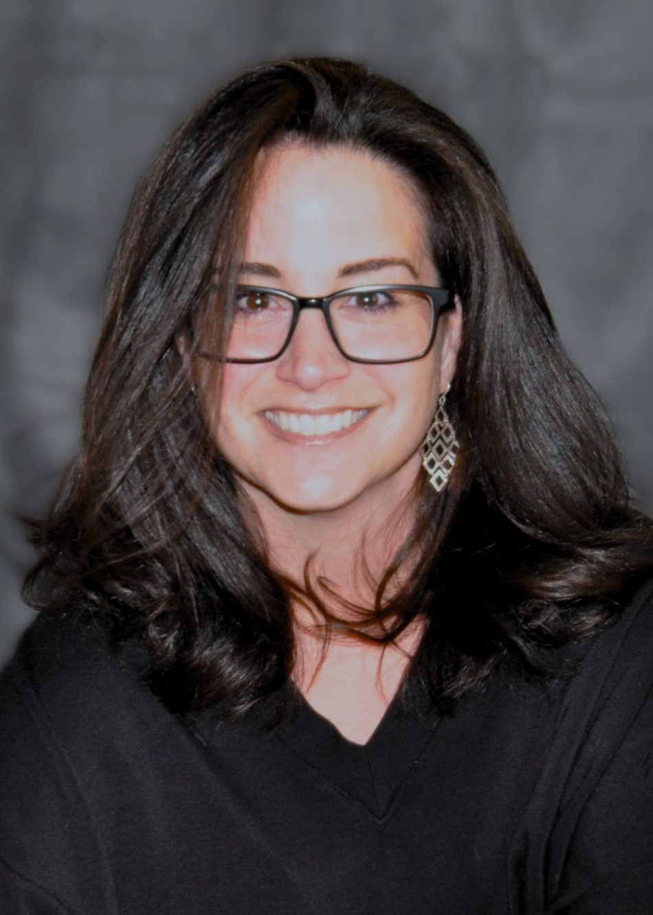 Photo of Dr. Consolino, wearing glasses and a black sweater.