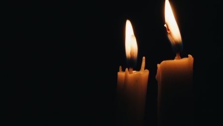 Two candles against a dark background
