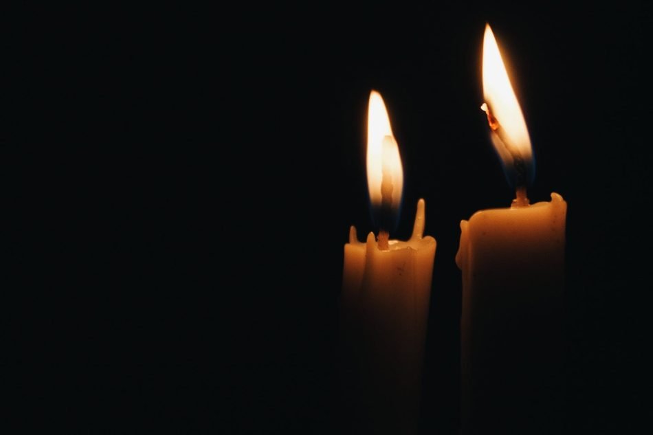 Two candles against a dark background