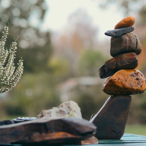 A photo rock cairn against a out-of-focus background.