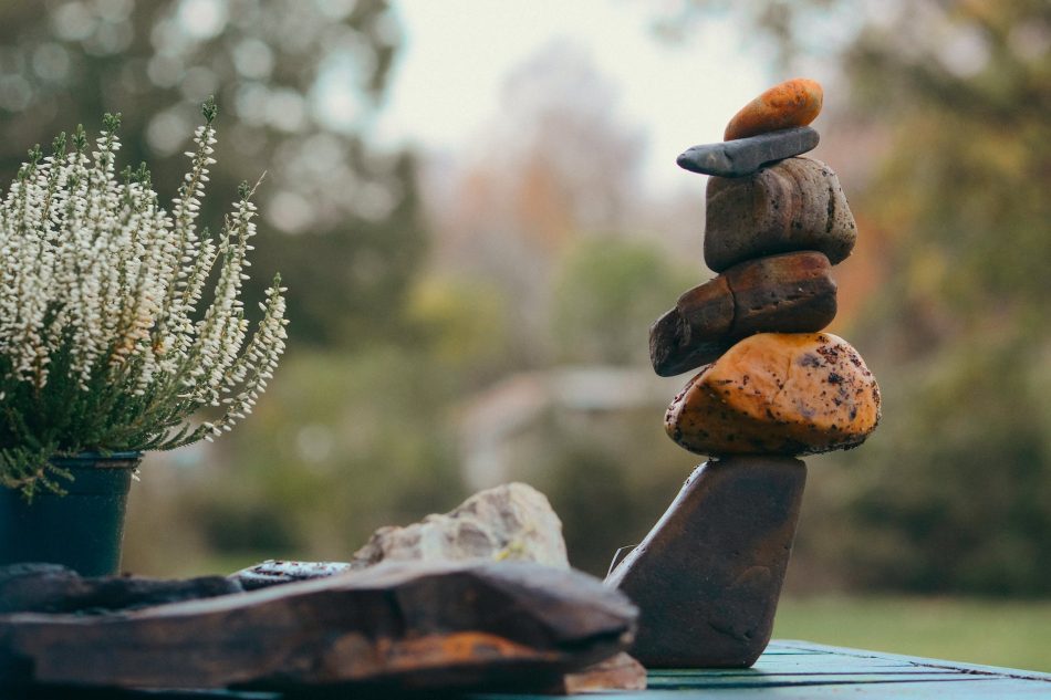 A photo rock cairn against a out-of-focus background.
